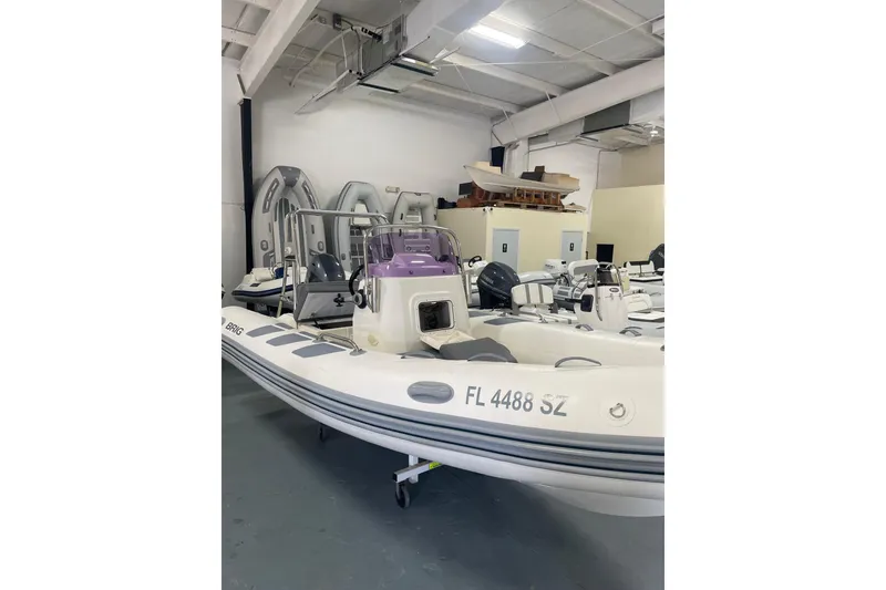 The Image of 2021 Brig Navigator 485 inflatable boat in showroom, featuring sleek design and modern equipment. - 0