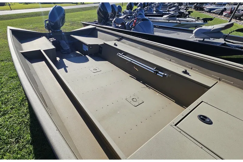 Slide: The Image of 2024 G3 Gator Tough 18 DK aluminum boat displayed on grass. - 7