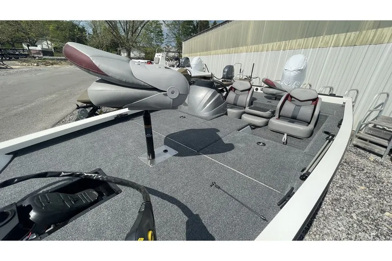 Slide: The Image of 2023 G3 Sportsman 1710 boat with gray seats and fishing gear. - 11