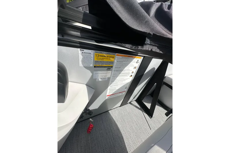 Slide: The Image of Interior of 2026 Godfrey Sweetwater 2286 SFL showing capacity warning label. - 10