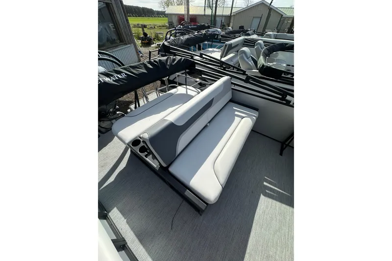 Slide: The Image of 2026 Godfrey Sweetwater 2286 SFL boat interior with white seating and cup holders. - 21