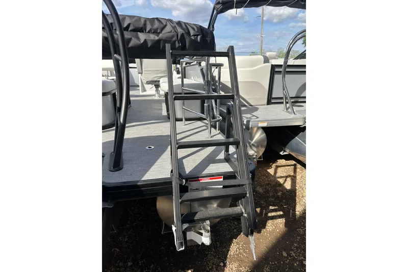 Slide: The Image of Ladder on 2026 Godfrey Sweetwater 2286 SFL pontoon boat under sunny skies. - 30