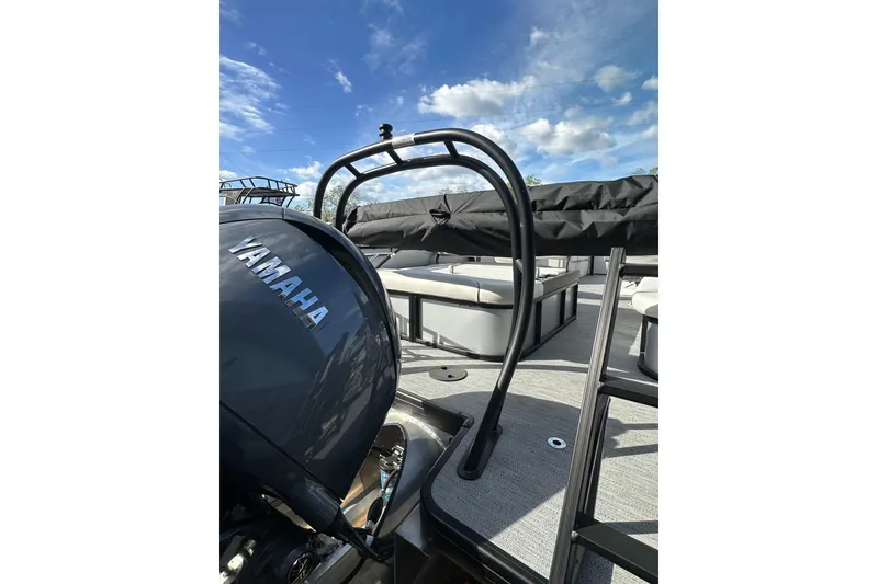 Slide: The Image of 2026 Godfrey Sweetwater 2286 SFL pontoon boat with Yamaha engine under blue sky. - 31