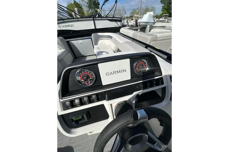 Slide: The Image of 2026 Godfrey Sweetwater 2286 SFL boat dashboard with Garmin display and gauges. - 9