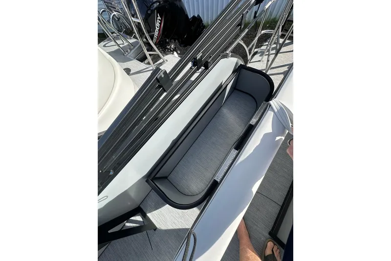 Slide: The Image of 2026 Godfrey Sweetwater 2286 SFL boat interior with storage compartment and Mercury engine. - 20