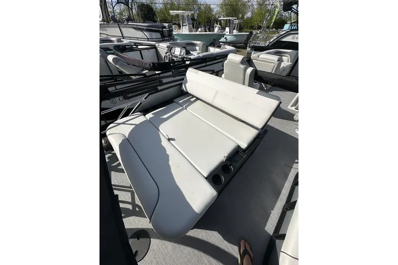 Slide: The Image of 2026 Godfrey Sweetwater 2286 SFL boat interior with white seating and cup holders. - 29