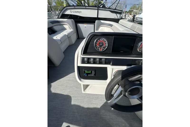 Slide: The Image of Interior view of 2026 Godfrey Sweetwater 2286 SFL boat, featuring modern dashboard and seating. - 8