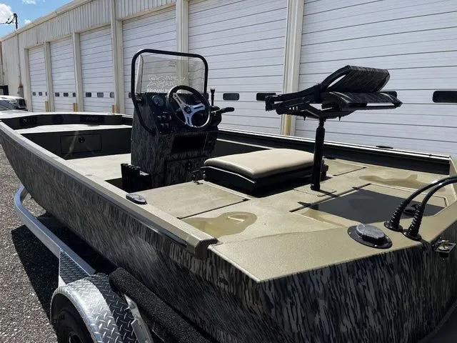 Slide: The Image of 2026 Thor LH1900CC boat with Baystar steering, parked in front of garages. - 14