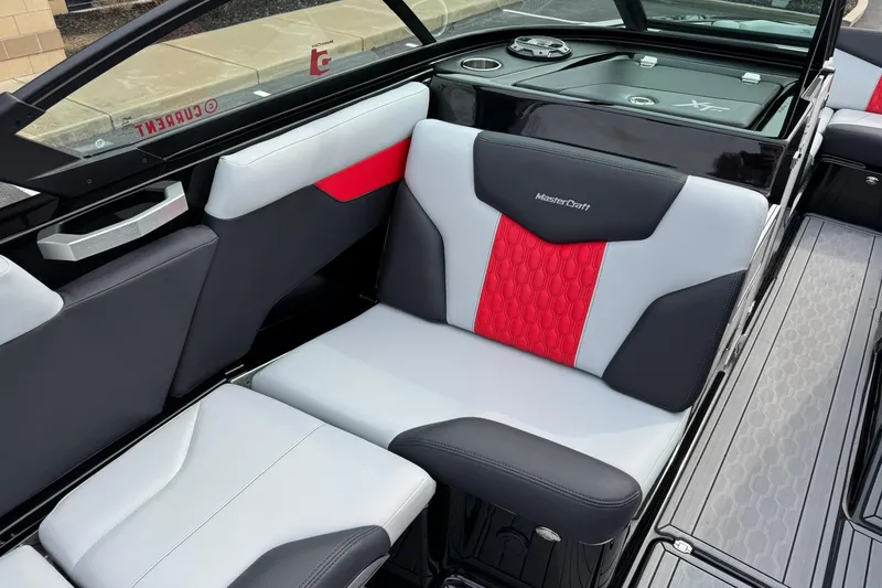 Slide: The Image of 2022 MasterCraft XT24 boat interior with stylish red and gray seating design. - 10