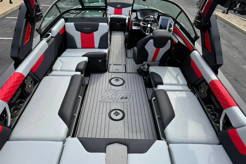 Slide: The Image of Interior of a 2022 MasterCraft XT24 boat with red and black seating. - 12