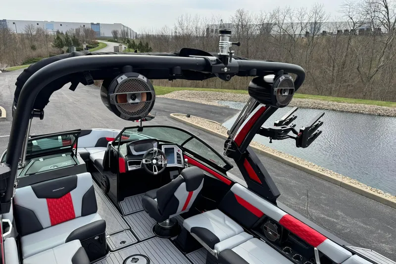 Slide: The Image of 2022 MasterCraft XT24 boat interior with modern seating and advanced audio system. - 13