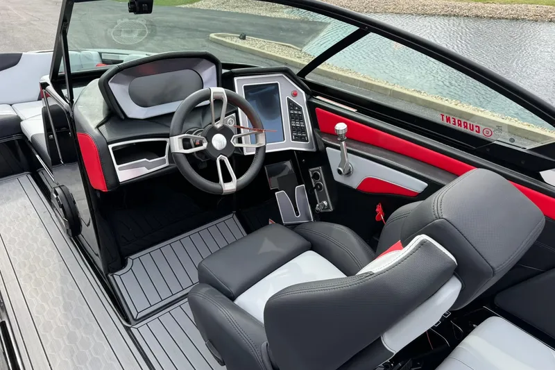 Slide: The Image of Interior of a 2022 MasterCraft XT24 boat with modern dashboard and steering wheel. - 8