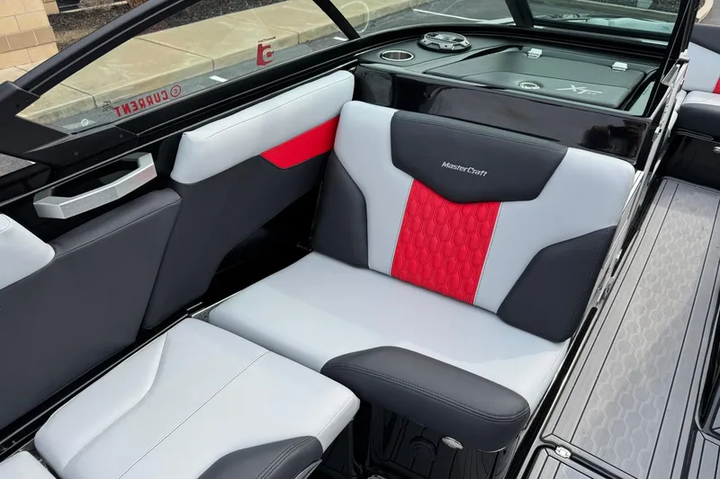 Slide: The Image of 2022 MasterCraft XT24 boat interior with stylish red and gray seating. - 9