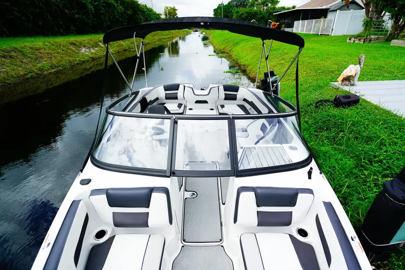 Slide: The Image of 2023 Yamaha Boats SX195 interior with sleek seating and water view. - 16