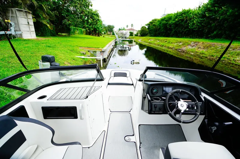 Slide: The Image of 2023 Yamaha Boats SX195 interior with sleek seating and modern dashboard design. - 8