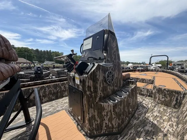Slide: The Image of Avid 21 MAG ST 2026 boat with camouflage design and control console. - 13
