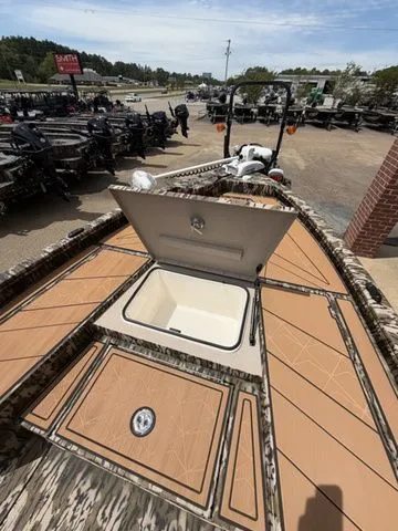 Slide: The Image of Avid 21 MAG ST 2026 boat with open storage hatch on parking lot. - 18