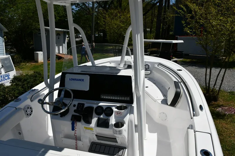 Slide: The Image of 2023 Tidewater 210 LXF boat interior with steering wheel and navigation system. - 11