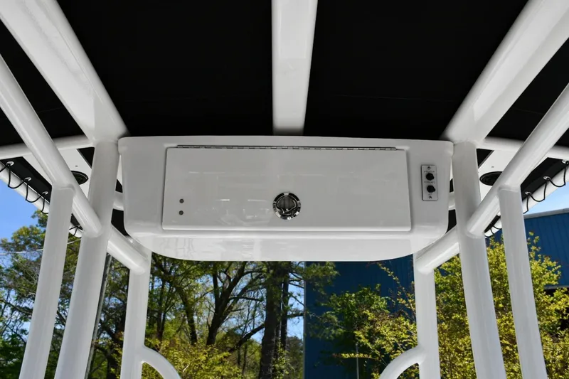 Slide: The Image of 2023 Tidewater 210 LXF boat console with overhead storage and controls. - 12