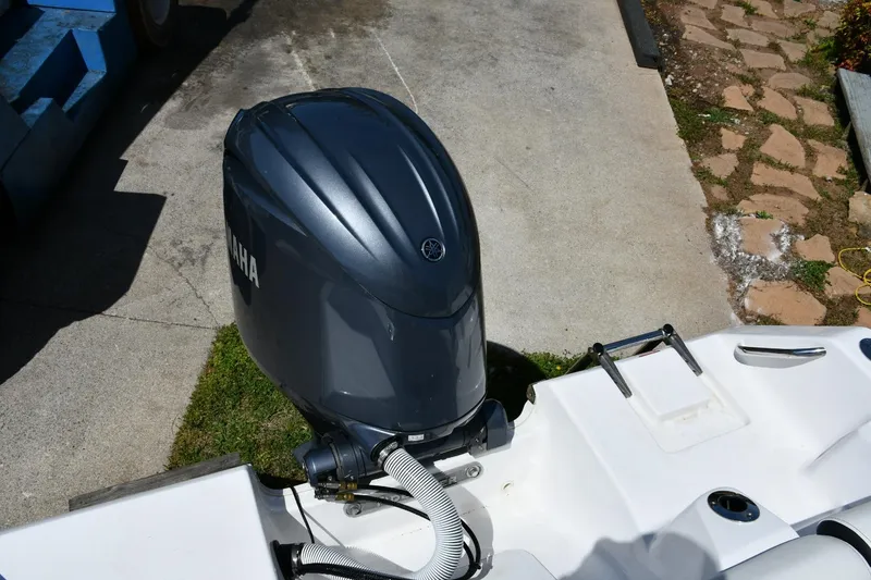 Slide: The Image of 2023 Tidewater 210 LXF boat with Yamaha outboard motor, docked on concrete. - 20