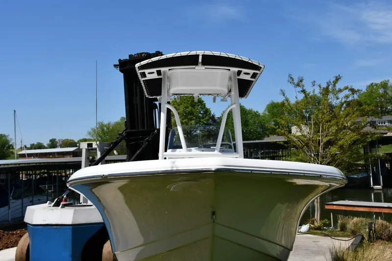 Slide: The Image of 2023 Tidewater 210 LXF boat docked under clear blue sky. - 4