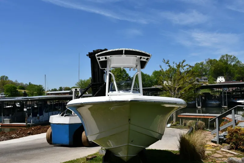 Slide: The Image of 2023 Tidewater 210 LXF boat docked at a marina under a clear blue sky. - 5