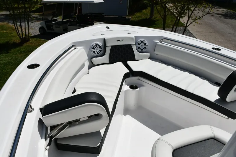 Slide: The Image of 2023 Tidewater 210 LXF boat interior with white seating and built-in speakers. - 8