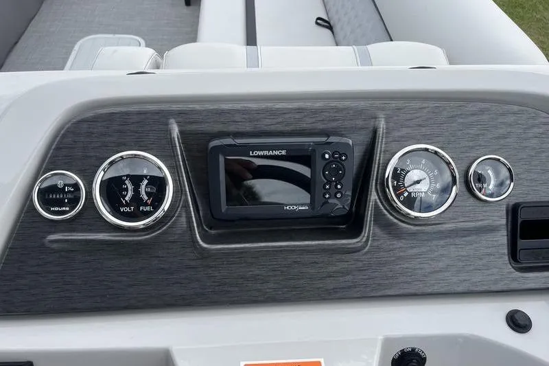 Slide: The Image of Dashboard of 2024 Crest Classic Platinum 240 SLC boat with gauges and Lowrance display. - 12