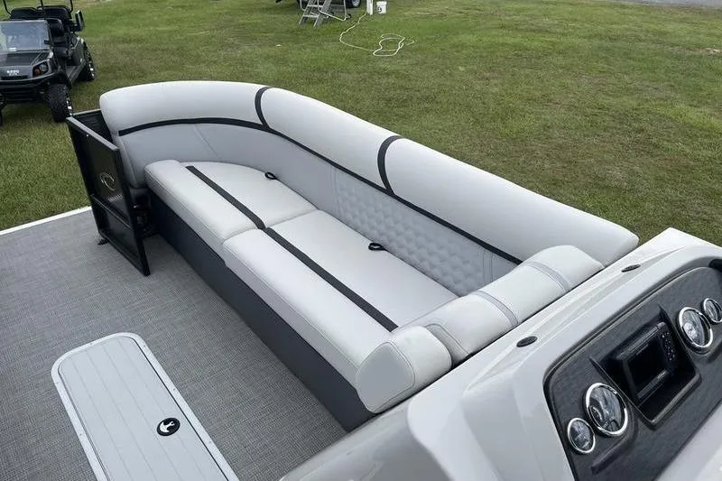 Slide: The Image of 2024 Crest Classic Platinum 240 SLC pontoon boat interior with plush seating and modern dashboard. - 18