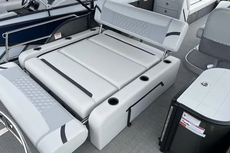 Slide: The Image of 2024 Crest Classic Platinum 240 SLC boat interior with luxurious seating and cup holders. - 5