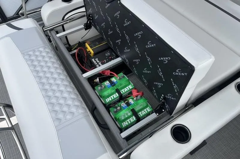Slide: The Image of 2024 Crest Classic Platinum 240 SLC boat battery compartment with Interstate batteries. - 6