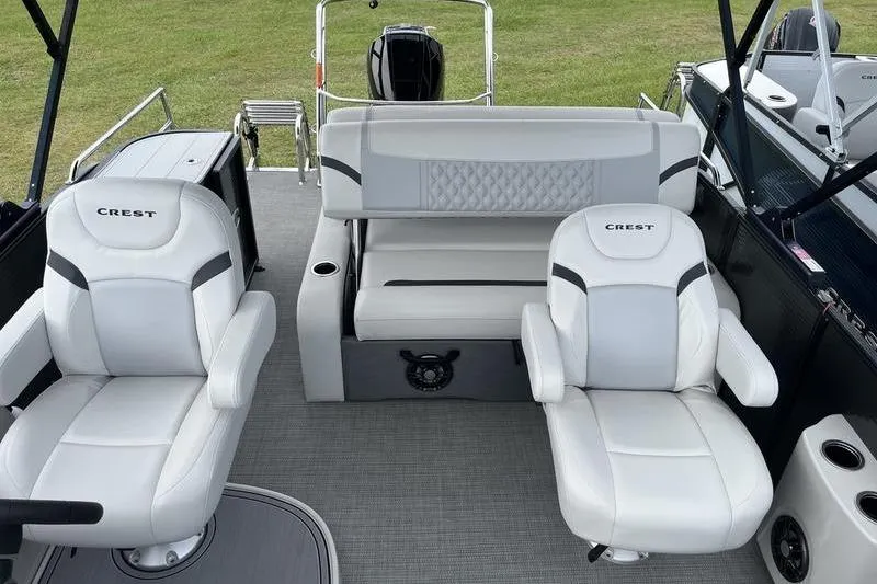 Slide: The Image of 2024 Crest Classic Platinum 240 SLC boat interior with luxurious white seating. - 7