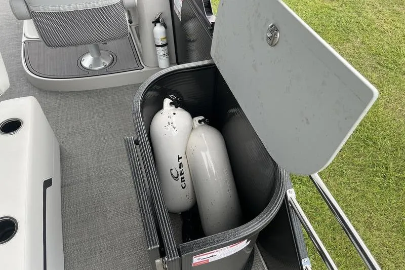 Slide: The Image of 2024 Crest Classic Platinum 240 SLC boat storage with gas cylinders and seating. - 8