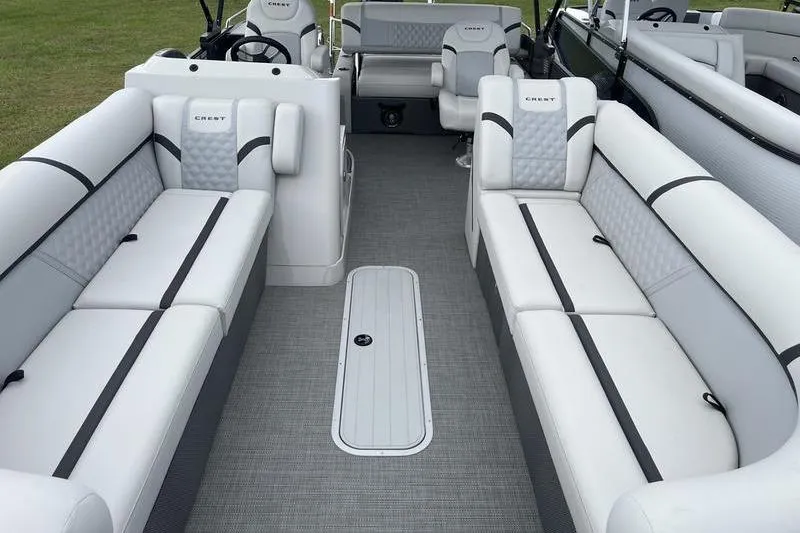 Slide: The Image of 2024 Crest Classic Platinum 240 SLC pontoon boat interior with luxurious seating and modern design. - 9
