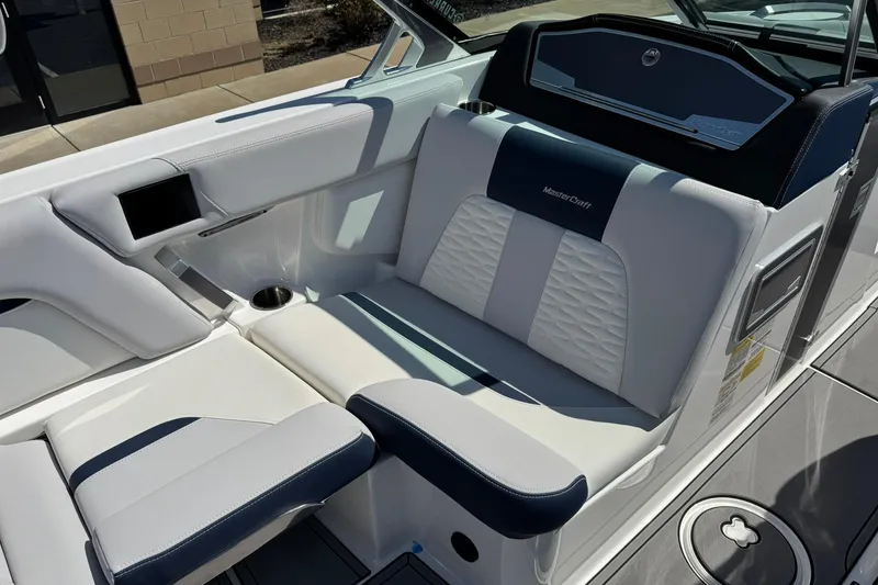 Slide: The Image of 2021 MasterCraft X24 boat interior with luxurious white and navy seating. - 10