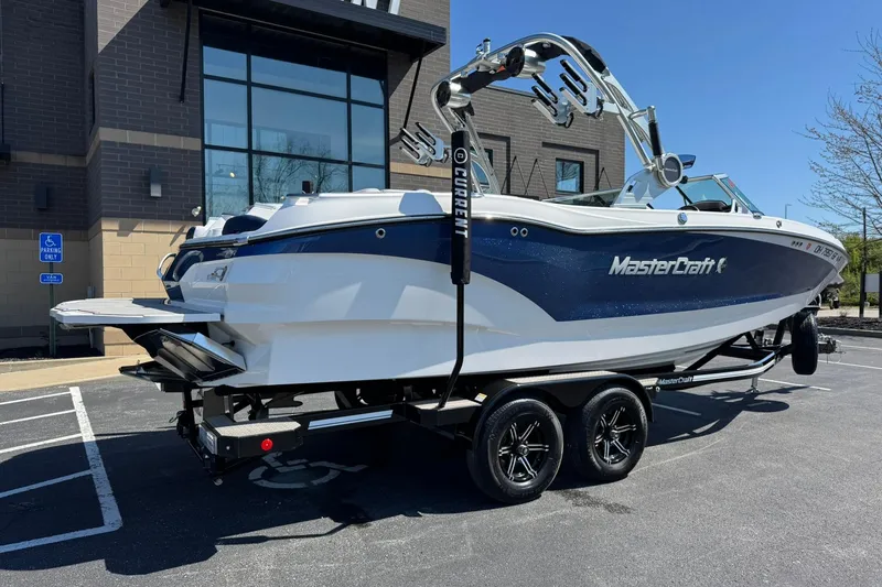 Slide: The Image of 2021 MasterCraft X24 boat on trailer, parked outside a building. - 3