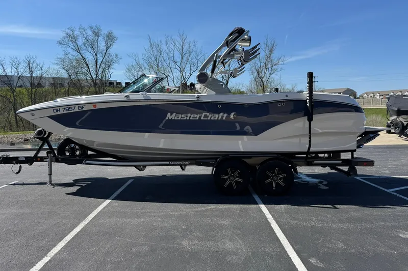 Slide: The Image of 2021 MasterCraft X24 boat on trailer in parking lot, side view. - 6