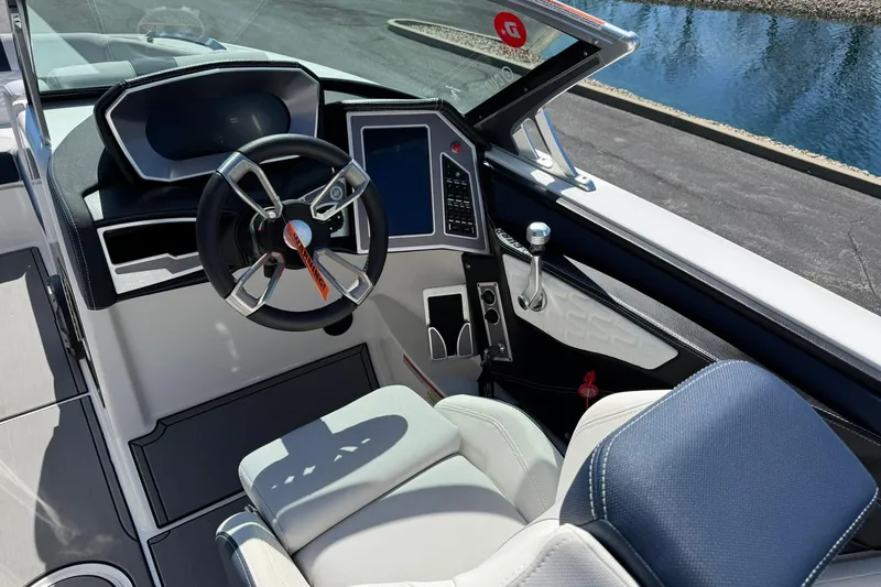 Slide: The Image of 2021 MasterCraft X24 boat cockpit with modern steering wheel and digital controls. - 9