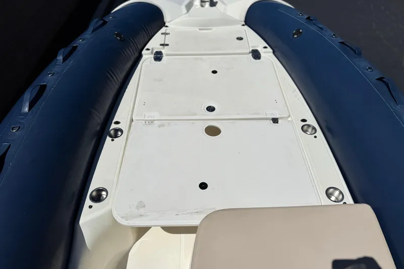 Slide: The Image of 2021 Zodiac N-ZO 680 boat deck with blue inflatable sides and white surface. - 12