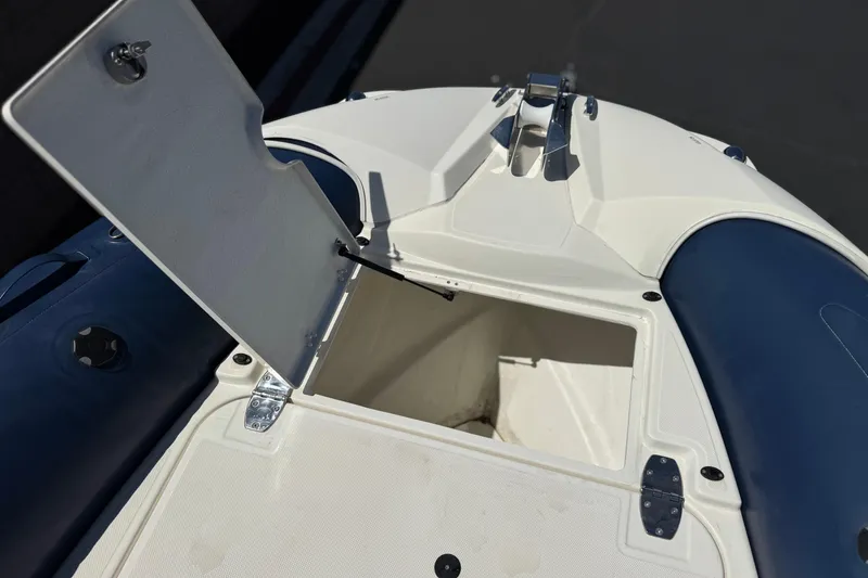 Slide: The Image of 2021 Zodiac N-ZO 680 boat storage compartment with open hatch, showcasing interior space. - 13