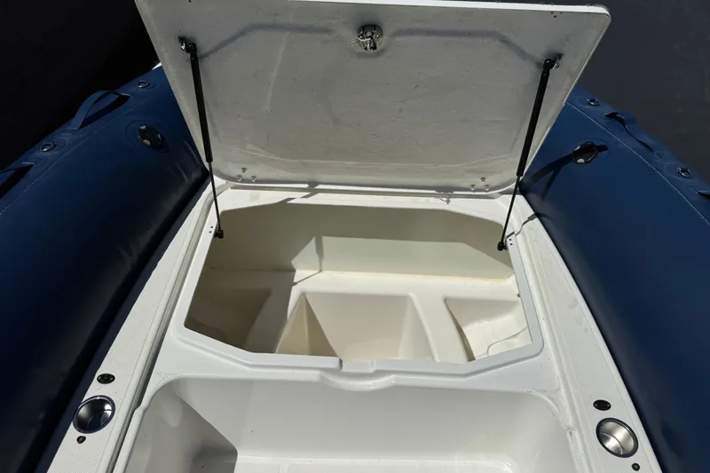 Slide: The Image of Open storage compartment on a 2021 Zodiac N-ZO 680 boat, showcasing interior space. - 14