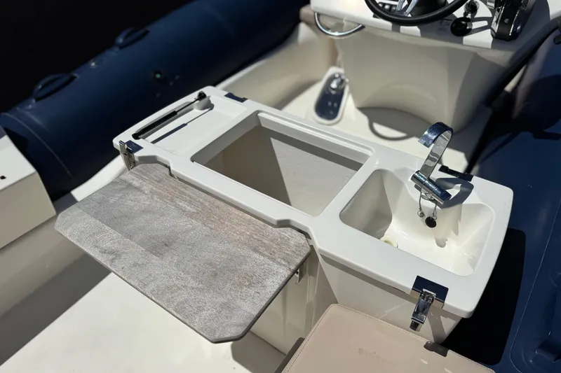 Slide: The Image of Interior view of 2021 Zodiac N-ZO 680 boat featuring sink and storage area. - 20