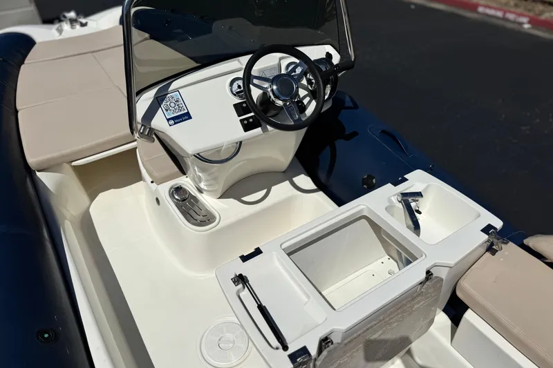 Slide: The Image of 2021 Zodiac N-ZO 680 boat interior with steering wheel and seating area. - 21