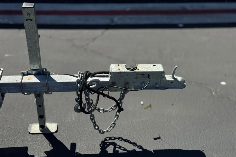 Slide: The Image of Trailer hitch with chains on a Zodiac N-ZO 680, 2021 model, parked on asphalt. - 24