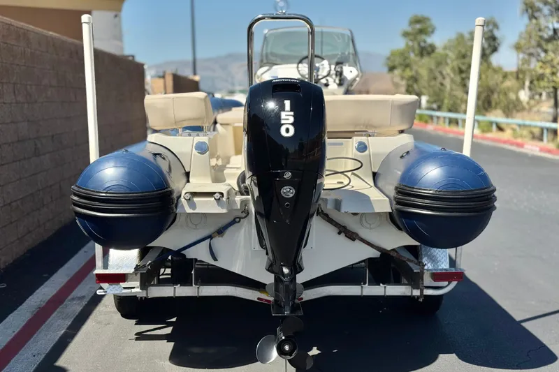 Slide: The Image of 2021 Zodiac N-ZO 680 boat with 150 HP outboard motor on a trailer. - 4