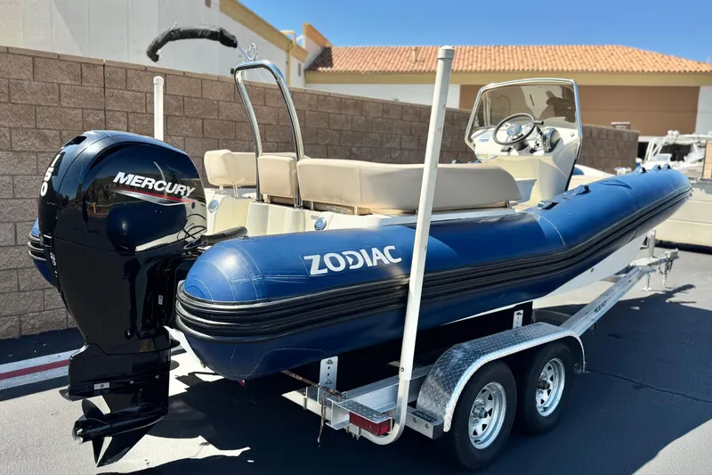 Slide: The Image of 2021 Zodiac N-ZO 680 inflatable boat with Mercury outboard motor on a trailer. - 5