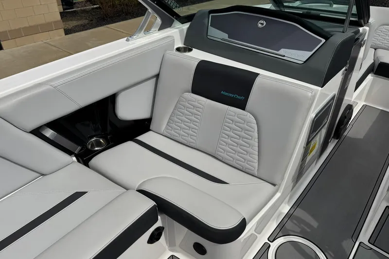 Slide: The Image of 2021 MasterCraft X22 boat interior with gray and black seating, featuring modern design elements. - 10