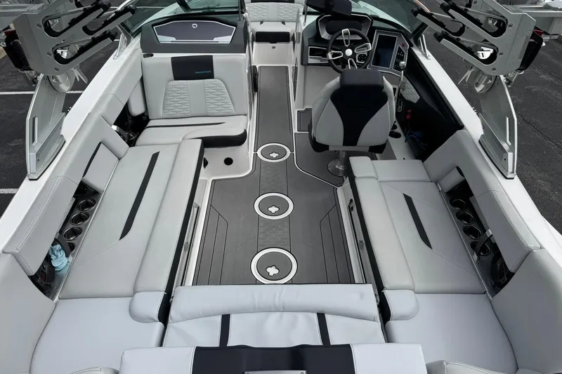 Slide: The Image of 2021 MasterCraft X22 boat interior with sleek seating and modern dashboard design. - 12
