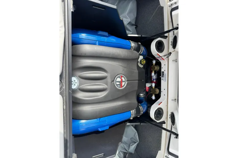 Slide: The Image of Engine compartment of a 2021 MasterCraft X22 boat, showcasing components and layout. - 13