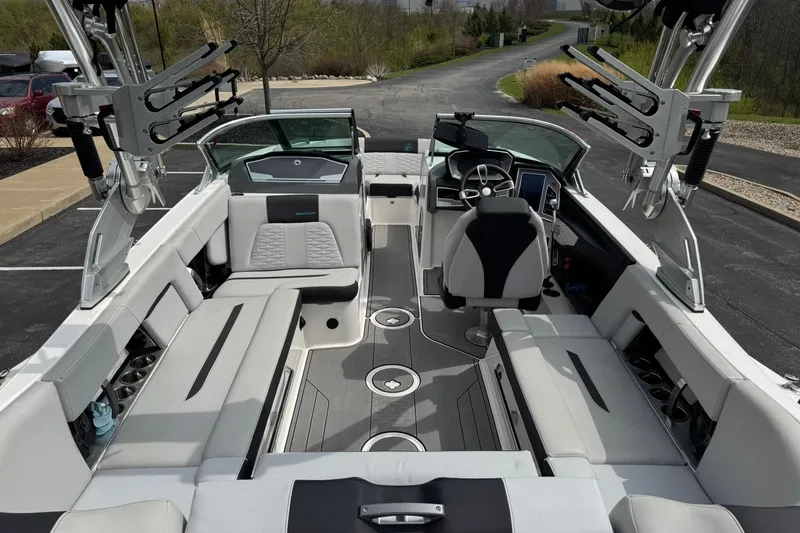 Slide: The Image of 2021 MasterCraft X22 boat interior with sleek seating and modern dashboard. - 14